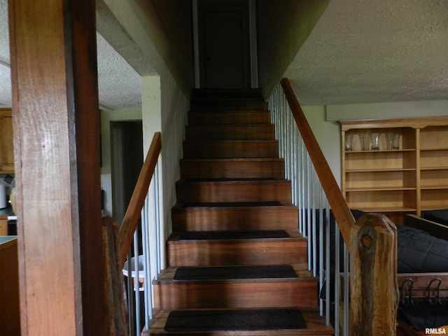 4370 Buncombe Rd, Vienna, IL 62995 - staircase with a textured ceiling
