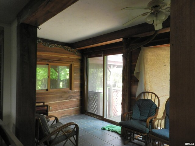 4370 Buncombe Rd, Vienna, IL 62995 - sitting room featuring ceiling fan, tile patterned floors, and wooden walls