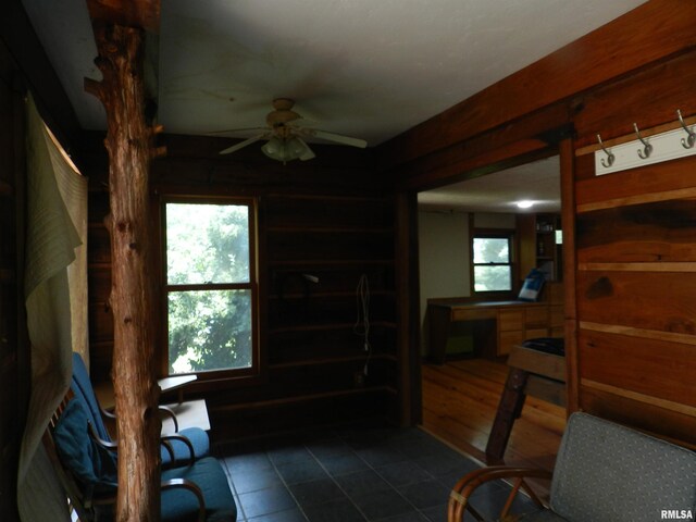 4370 Buncombe Rd, Vienna, IL 62995 - interior space featuring ceiling fan, dark tile patterned flooring, and wood walls