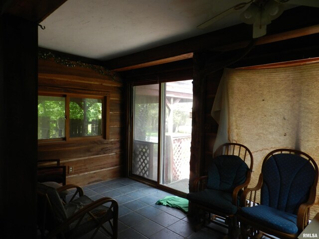 4370 Buncombe Rd, Vienna, IL 62995 - living area with tile patterned flooring, a ceiling fan, and wooden walls