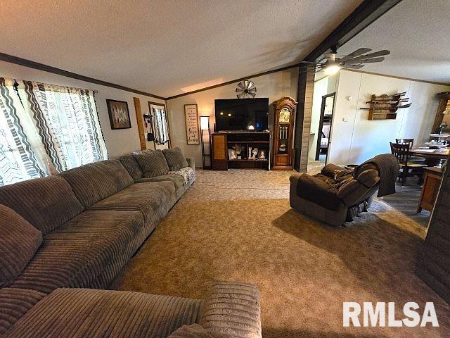 18802 E Fairfield Rd, Mount Vernon, IL 62864 - living room with ornamental molding, carpet floors, a textured ceiling, lofted ceiling, and a ceiling fan