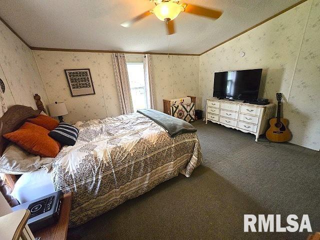 18802 E Fairfield Rd, Mount Vernon, IL 62864 - carpeted bedroom with lofted ceiling, wallpapered walls, crown molding, ceiling fan, and a textured ceiling