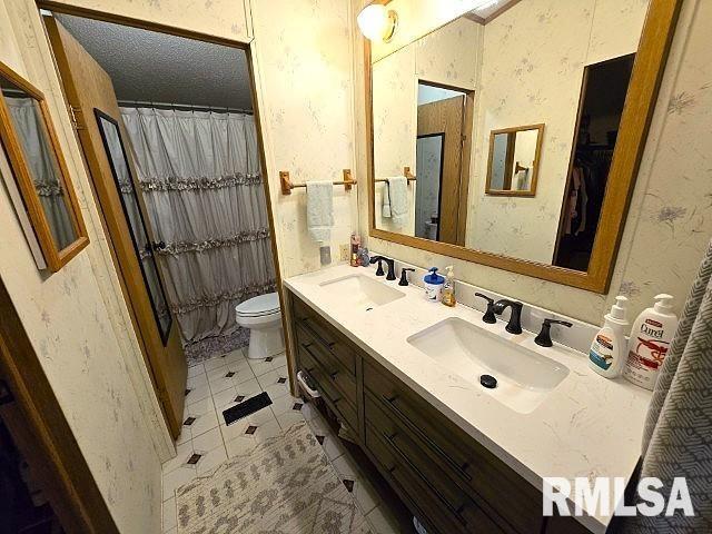 18802 E Fairfield Rd, Mount Vernon, IL 62864 - bathroom featuring double vanity, tile patterned floors, wallpapered walls, and curtained shower