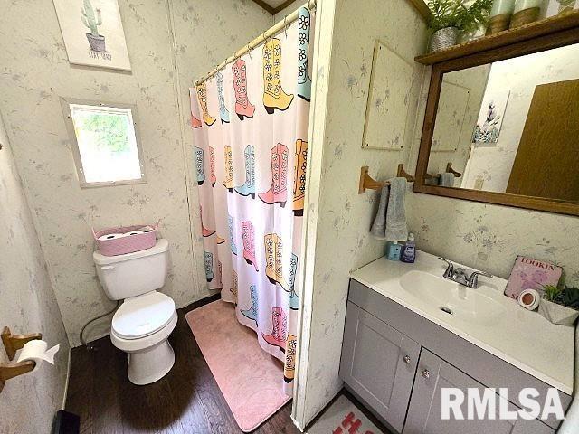 18802 E Fairfield Rd, Mount Vernon, IL 62864 - full bath featuring wood finished floors, vanity, and a shower with shower curtain