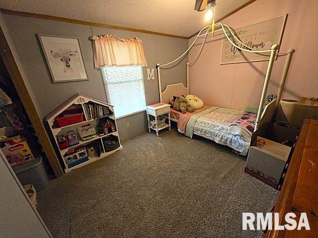 18802 E Fairfield Rd, Mount Vernon, IL 62864 - carpeted bedroom with ornamental molding, a ceiling fan, and a textured ceiling