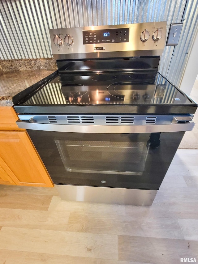 719 E Cherry St, Olney, IL 62450 - kitchen view of stainless steel electric range oven and wood finished floors