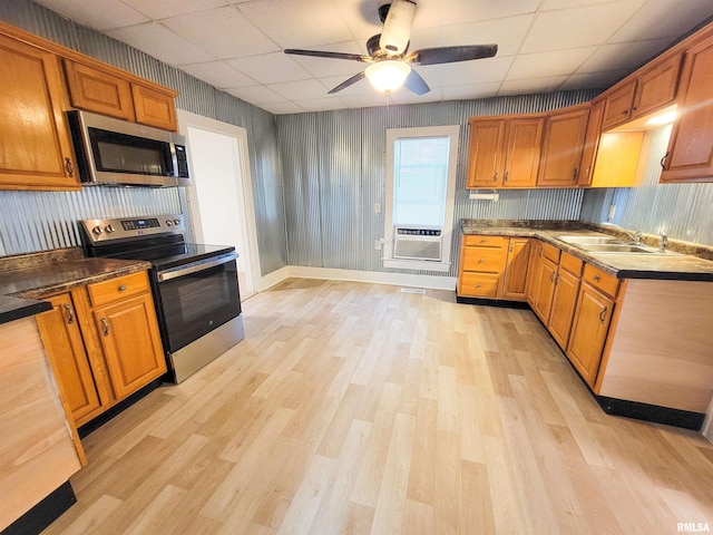 719 E Cherry St, Olney, IL 62450 - kitchen with stainless steel appliances, a paneled ceiling, light wood finished floors, ceiling fan, and brown cabinetry