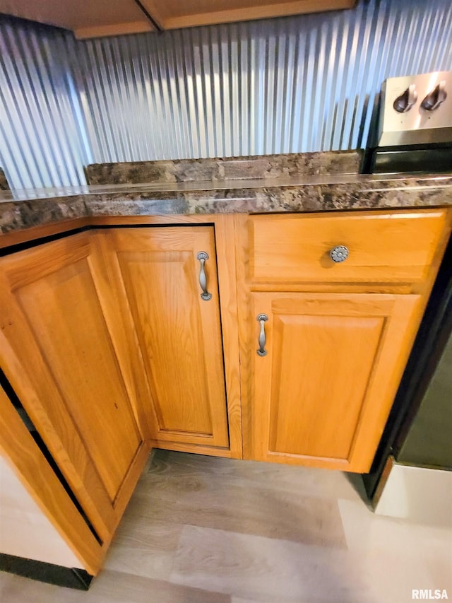 719 E Cherry St, Olney, IL 62450 - kitchen view of dark countertops, stainless steel range, and wood finished floors