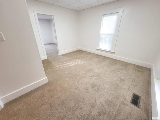 719 E Cherry St, Olney, IL 62450 - carpeted empty room featuring baseboards and a drop ceiling