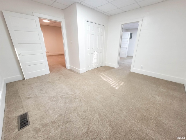 719 E Cherry St, Olney, IL 62450 - unfurnished bedroom featuring a drop ceiling, carpet, and a closet