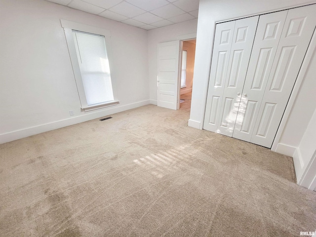 719 E Cherry St, Olney, IL 62450 - unfurnished bedroom featuring carpet floors, a drop ceiling, and a closet
