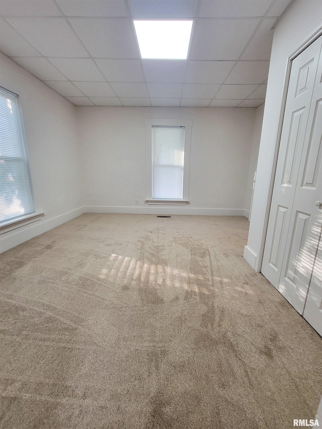 719 E Cherry St, Olney, IL 62450 - empty room with carpet, a drop ceiling, and plenty of natural light