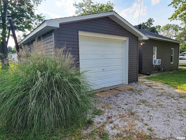 719 E Cherry St, Olney, IL 62450 - garage featuring driveway and cooling unit