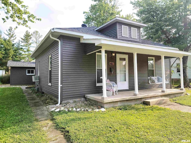 719 E Cherry St, Olney, IL 62450 - bungalow-style home with a porch, a front yard, and cooling unit