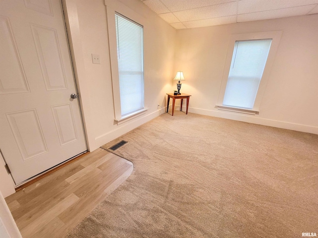 719 E Cherry St, Olney, IL 62450 - unfurnished room featuring a drop ceiling, carpet, and wood finished floors