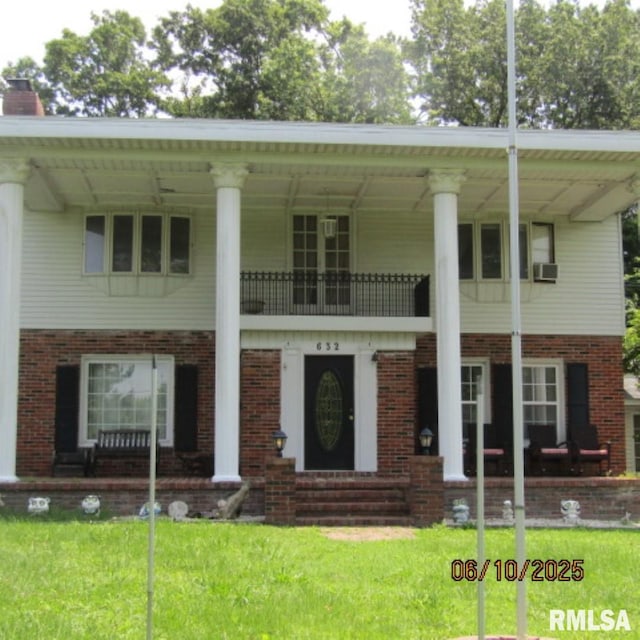 632 N Pershing St, Energy, IL 62933 - neoclassical / greek revival house featuring a balcony, a front yard, brick siding, and a chimney