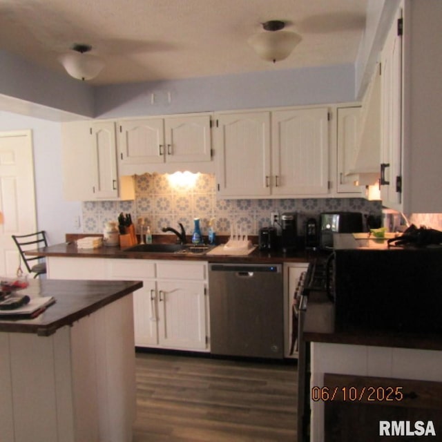 632 N Pershing St, Energy, IL 62933 - kitchen featuring stainless steel dishwasher, dark countertops, white cabinets, tasteful backsplash, and dark wood-style flooring