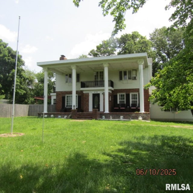 632 N Pershing St, Energy, IL 62933 - back of house with a chimney, a porch, brick siding, and a balcony