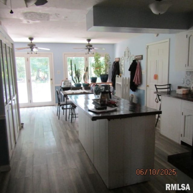 632 N Pershing St, Energy, IL 62933 - kitchen with ceiling fan, dark countertops, wood finished floors, and white cabinets