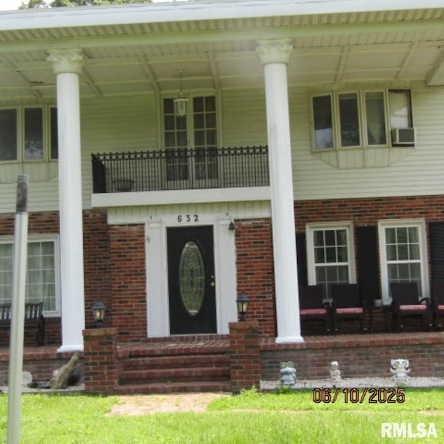 632 N Pershing St, Energy, IL 62933 - neoclassical home featuring brick siding, cooling unit, and covered porch
