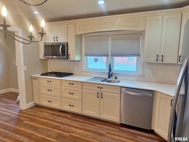 2223 N Ave, Metropolis, IL 62960 - kitchen with appliances with stainless steel finishes, decorative backsplash, dark wood finished floors, light countertops, and recessed lighting