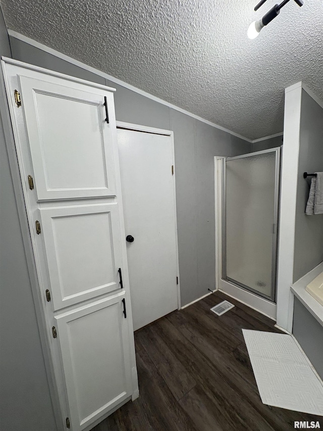 715 Wastena St, Benton, IL 62812 - bathroom with a textured ceiling, a shower stall, wood finished floors, and crown molding