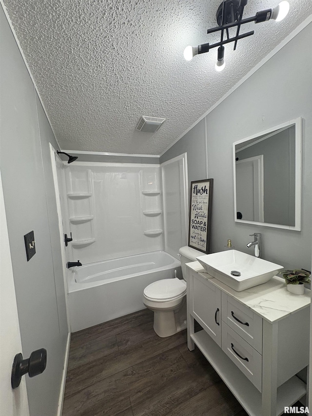 715 Wastena St, Benton, IL 62812 - bathroom featuring a textured ceiling, vanity, wood finished floors, and tub / shower combination