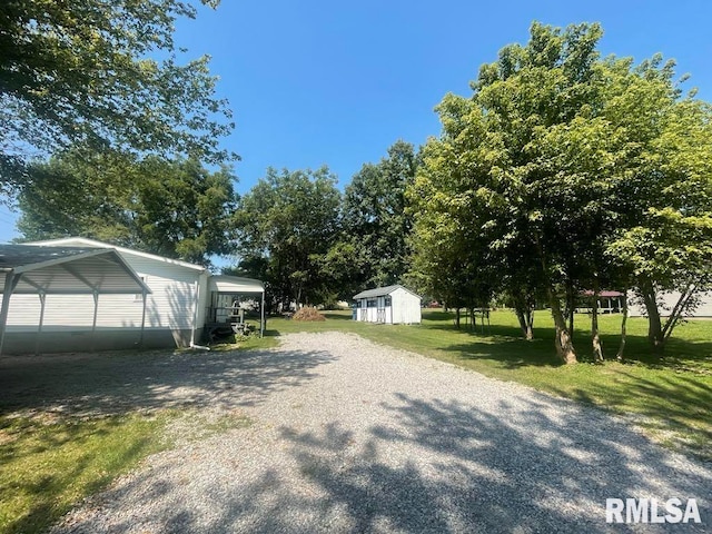 715 Wastena St, Benton, IL 62812 - view of green lawn with a storage shed and driveway