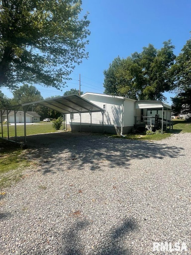 715 Wastena St, Benton, IL 62812 - view of parking / parking lot featuring driveway and a detached carport