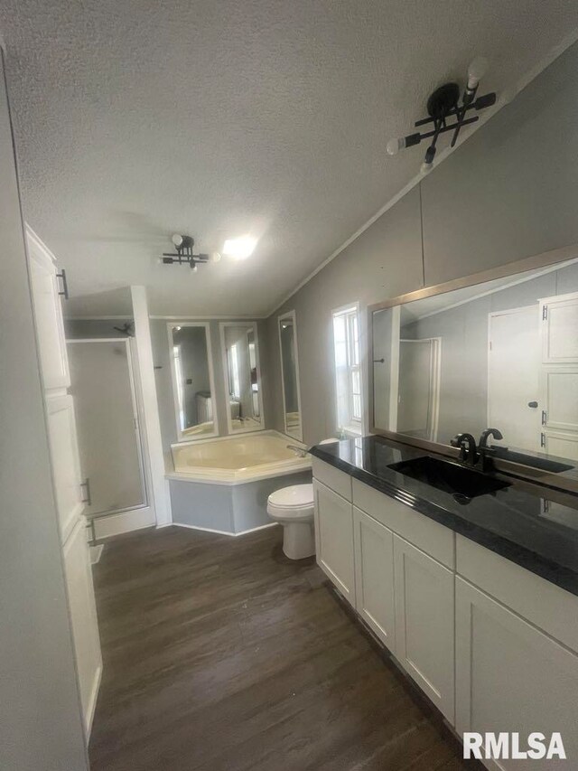 715 Wastena St, Benton, IL 62812 - bathroom featuring a textured ceiling, a shower stall, vaulted ceiling, wood finished floors, and a bath
