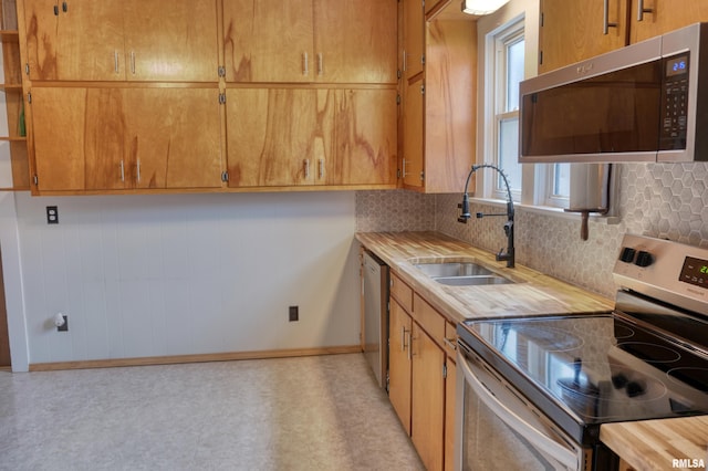 2036 Spruce St, Murphysboro, IL 62966 - kitchen with stainless steel appliances, open shelves, backsplash, light floors, and wood counters