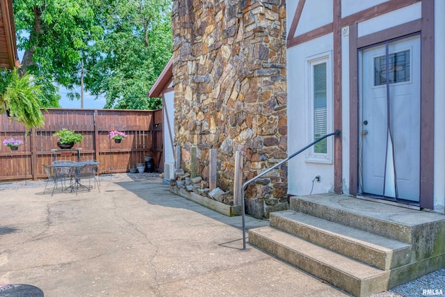 2036 Spruce St, Murphysboro, IL 62966 - property entrance with a patio area, stone siding, and outdoor dining area