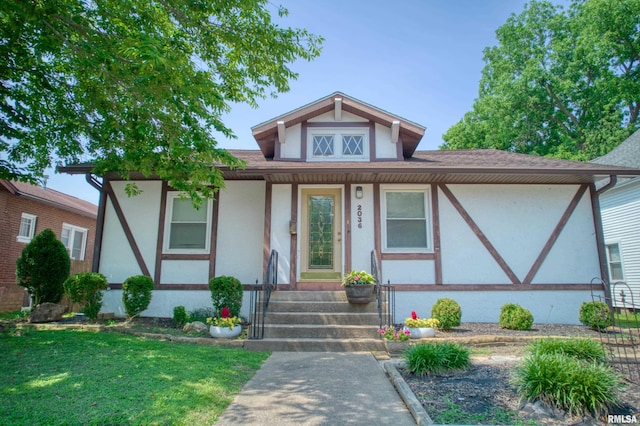 2036 Spruce St, Murphysboro, IL 62966 - view of front facade featuring stucco siding, a shingled roof, and covered porch
