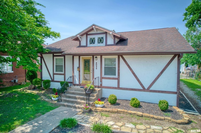 2036 Spruce St, Murphysboro, IL 62966 - english style home featuring stucco siding, a shingled roof, and a front lawn
