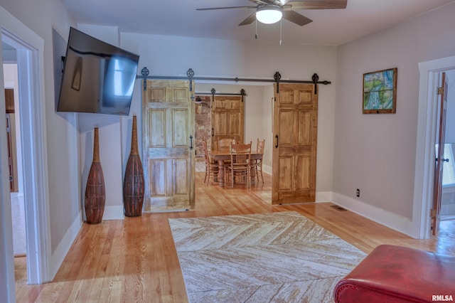 2036 Spruce St, Murphysboro, IL 62966 - bedroom featuring a barn door, wood finished floors, and a ceiling fan