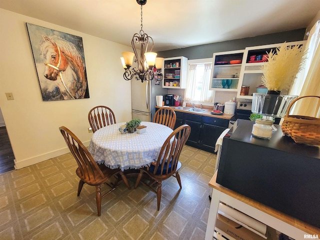 511 W 4th St, Flora, IL 62839 - dining space featuring tile patterned floors and a chandelier