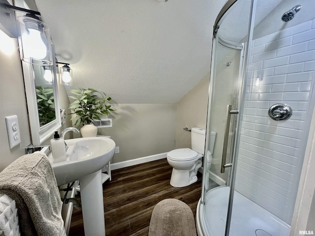 314 W 12th St, Metropolis, IL 62960 - bathroom featuring a stall shower, wood finished floors, lofted ceiling, and a textured ceiling