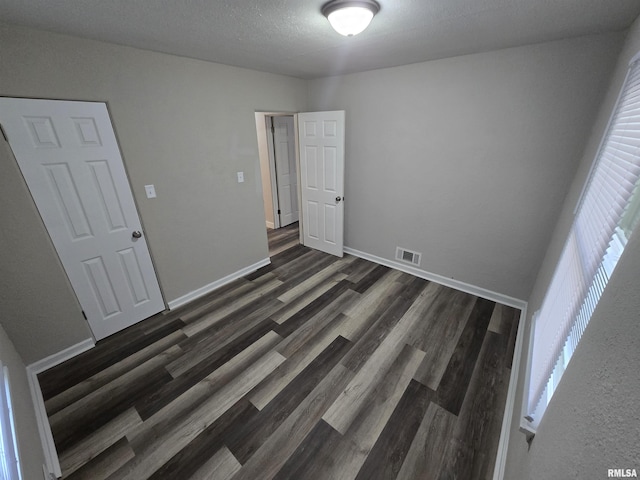 832 Fairfield Rd, Mount Vernon, IL 62864 - unfurnished bedroom with dark wood finished floors and baseboards