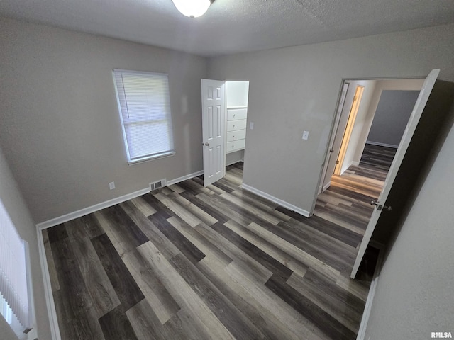 832 Fairfield Rd, Mount Vernon, IL 62864 - unfurnished bedroom featuring dark wood-type flooring