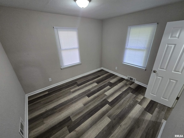 832 Fairfield Rd, Mount Vernon, IL 62864 - unfurnished bedroom featuring dark wood-style floors and baseboards