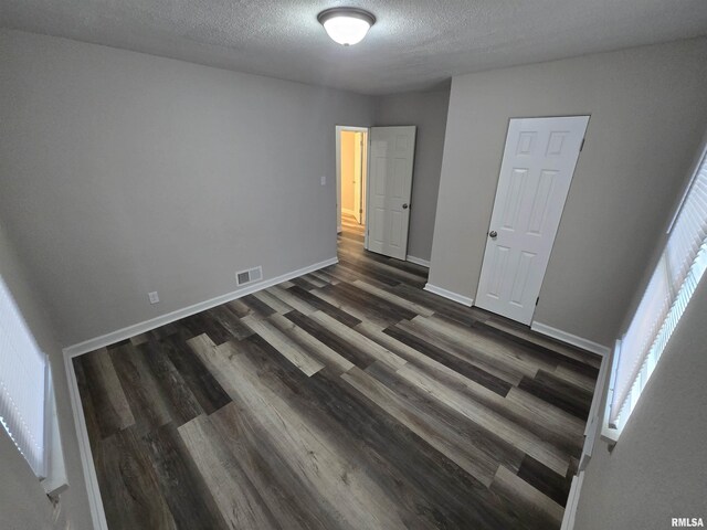 832 Fairfield Rd, Mount Vernon, IL 62864 - unfurnished bedroom with dark wood-type flooring and a textured ceiling