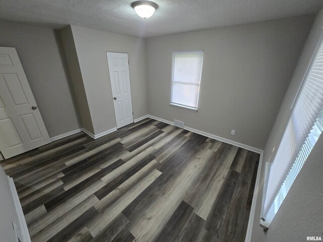 832 Fairfield Rd, Mount Vernon, IL 62864 - unfurnished bedroom with dark wood-style floors and a textured ceiling