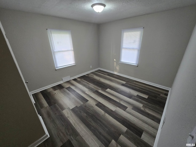 832 Fairfield Rd, Mount Vernon, IL 62864 - unfurnished room with a textured ceiling and dark wood-style flooring