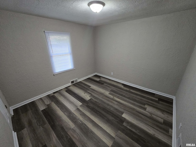 832 Fairfield Rd, Mount Vernon, IL 62864 - unfurnished room featuring a textured wall, dark wood-style floors, and a textured ceiling
