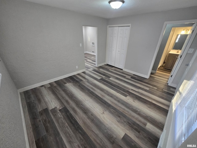 832 Fairfield Rd, Mount Vernon, IL 62864 - unfurnished bedroom with dark wood finished floors, a closet, and a textured wall