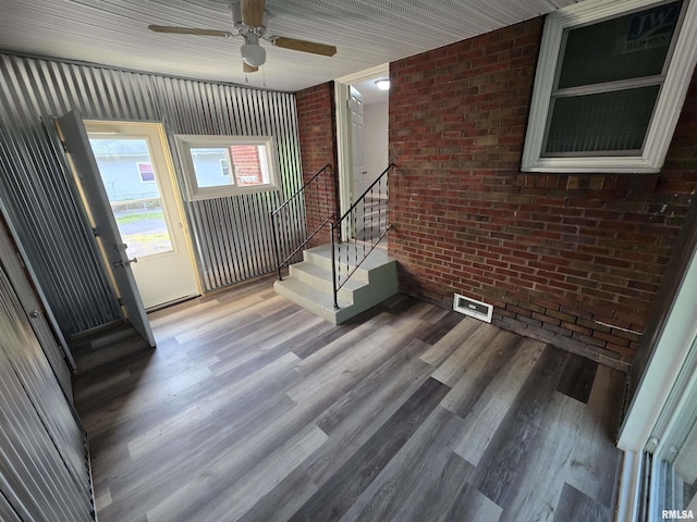 832 Fairfield Rd, Mount Vernon, IL 62864 - foyer entrance with brick wall, stairway, wood finished floors, and ceiling fan