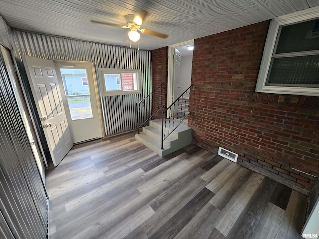 832 Fairfield Rd, Mount Vernon, IL 62864 - entrance foyer with brick wall, stairway, wood finished floors, and ceiling fan