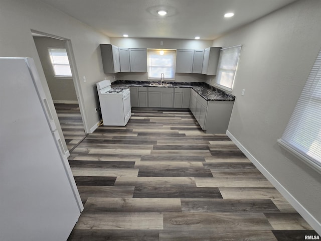 832 Fairfield Rd, Mount Vernon, IL 62864 - kitchen featuring white appliances, gray cabinets, dark countertops, plenty of natural light, and recessed lighting