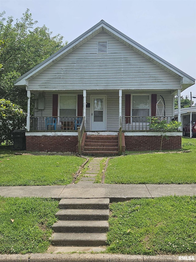 123 W College St, Harrisburg, IL 62946 - bungalow with a porch and a front yard