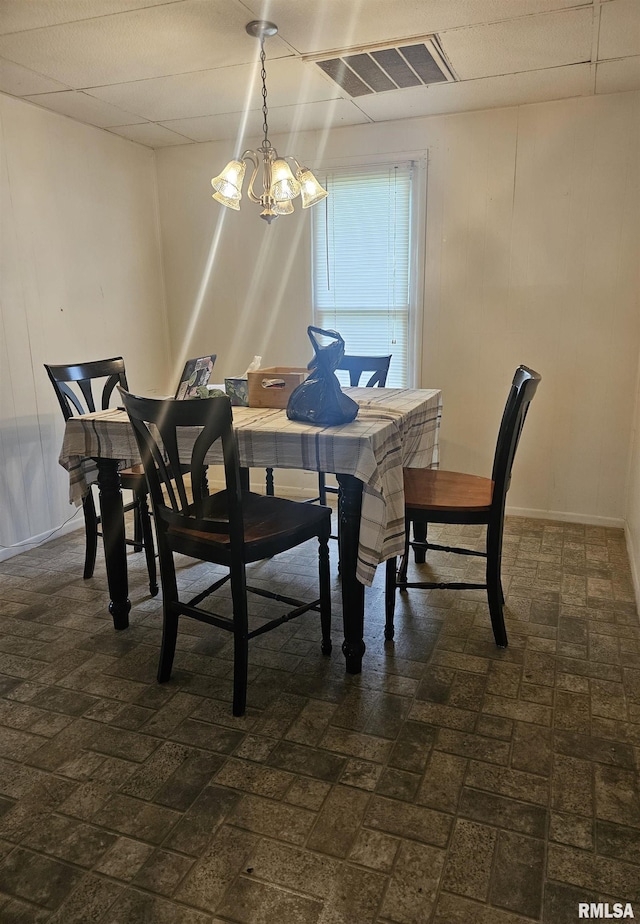 123 W College St, Harrisburg, IL 62946 - dining space with brick patterned floors and a chandelier